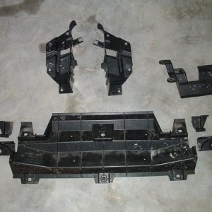 Plastic under panels that were removed. Small pcs at the side of the larger panel were cut away. Top 2 pcs had a slot cut to fit around the alum uprig