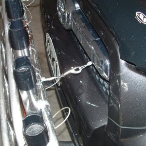 Upper support cables from rack through grill to upper radiator support crossmember. Used ss quick snap links for easy removal