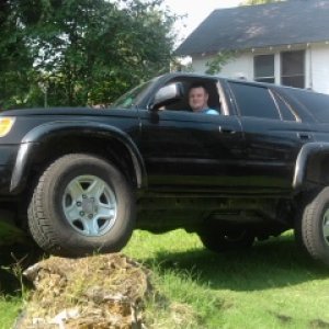 Playing on a stump after taking running boards and tow hitch off