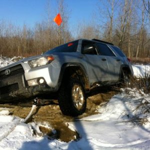 Ice covered hole. It did not look deep, but was. Result = Stuck. Did not have locker engaged. Exhaust was well under water