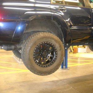 On the lift at work installing the Pro Comp wheels with a set of 295/70R17 Nitto Terra Grappler tires.