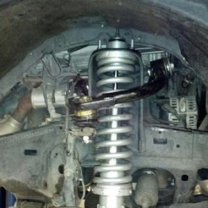 Another shot of the front coilover. Light racing upper control arm installed.