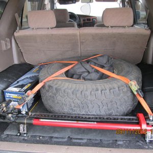 Moved the spare for extra gound clearance.  Smitty Bilt HO air compressor in the spare.  Extra CV axle with life time warranty.  High Lift Jack and mo