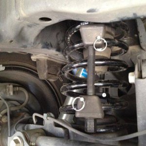 Put spring compressors when car is parked on level surface (remove spare to gain access)