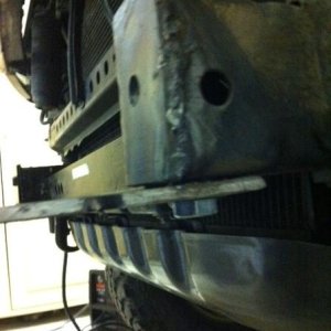 Bolt through bottom of frame rail.
