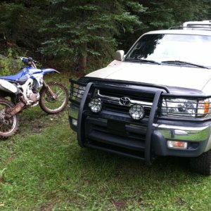 Playing in the mud with the YZ450 and my faithful runner