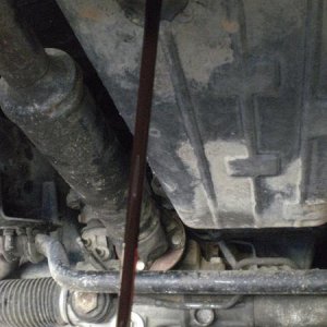 nasty (not red) old transmission fluid draining.