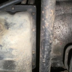 The bolts forward of the pan and aft of the engine. No need to remove the sway bar.