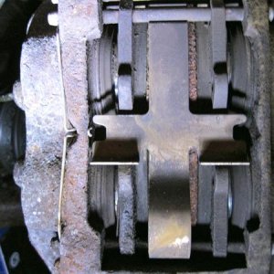 Old rotor and caliper. There was decent meat on the old pads, but upon further inspection they were wearing unevenly and glazing. The rotors were scar