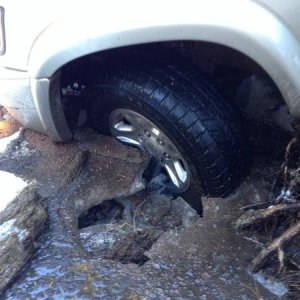 View of the front wheel and why I was locked into place. That ice was so thick that I had to drop big rocks on it to break it up so I could move.