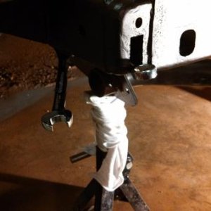 Re-attaching the receiver hitch via access holes.