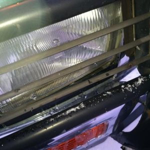 My broken headlight and pushed in brush guard