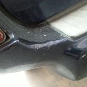 Close up of quarter panel and busted reflector.