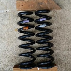 Purple/grey spring for DRIVER side
Orange/Grey Spring for PASSENGER side

Driver side spring has one more coil and uses a larger diameter wire for hig