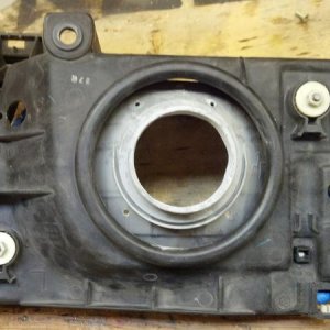 The two white plastic pieces adjust the angle of the headlamps. In my opinion you should align you projector coaxially with the bore of the thing stic