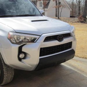 Emblem and lower bumper cover