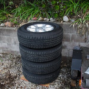 4x 265/70/17 Bridgestone Dueler H/T tires, stock wheels, caps and lugs