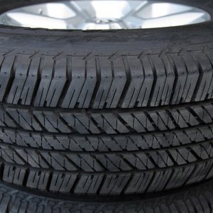 4x 265/70/17 Bridgestone Dueler H/T tires, stock wheels, caps and lugs