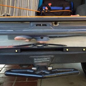 Installed in aluminum rails above the tow hitch.