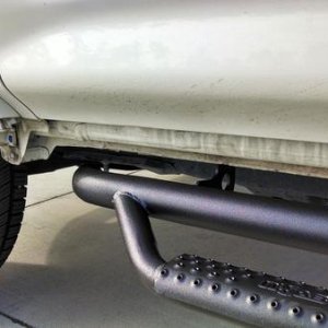 Driver's Side front quarter - close up of nFab bars w/o OEM skirts