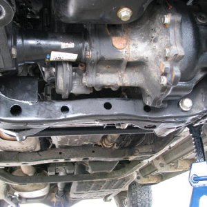 Underside including tranny cross member, with 2 small holes...