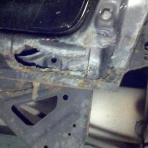 Drivers side below door sill.