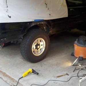 Beginning to grind out the rust from above the wheel well.