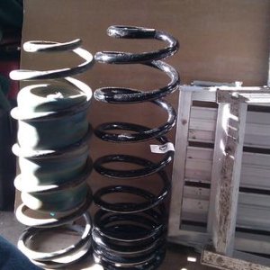 Stock 98 spring with blown firestone airbag on left.  shiny new 890 on the right.