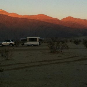 Camping with Coleman tent trailer under full moon