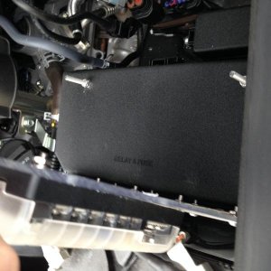 Fasteners mounted to factory cover