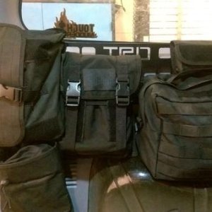 Here it is installed with the pouches attached. It holds my jumper cables, tow straps, bungee cords, and an entire tool kit. It freed up a lot of room