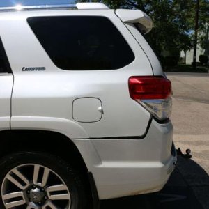 Driver side rear, small damage to bumper cover only, one bolting eye torn, small crack in lower bumper (out of view here).