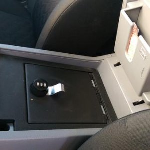 Locking gun safe in factory console.