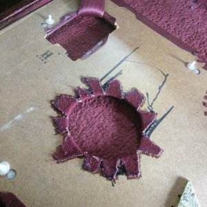 Marked the back side of the panel with the opening in the sheet metal, cut panel with serrated knife, glued carpet to backside of panel.