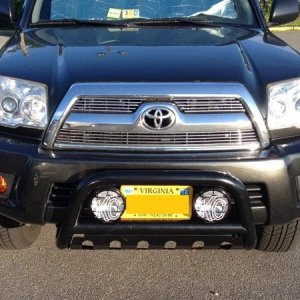 Billet grille, amber fog light film, bull bar, and new KC fog lights.