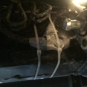 Breather tube junction from two to one underneath driver footwell