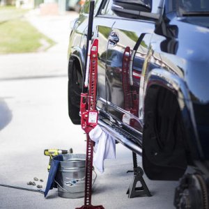 just for shits and giggles we decided to use our new C4 Fab Rock Sliders with our hilift to work on cleaning and repainting some of the frame and whee