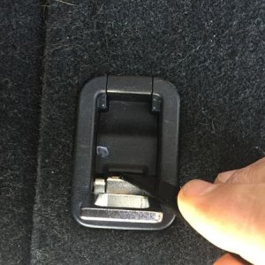 Step 1:  Lift rear most tie downs on both sides and pry up bolt cover.