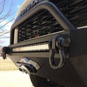 Daystar Black Winch Isolator Kit (KU70046BK)

http://www.amazon.com/Daystar-KU70046BK-Black-Winch-Isolator/dp/B001GH5PRO

Dremel may be required to re