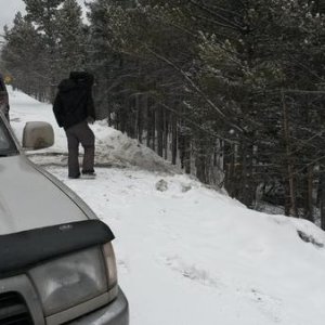 My buddy surveying the predicament we just got out of. We still got a half day of skiing and riding in after!