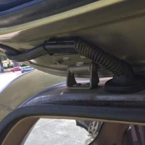 Cables ran up the inside of the rear hatch door, through the black rubber tube, into the overhead lining.