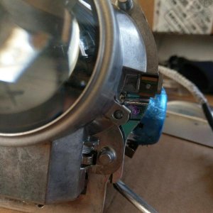 I broke a screw for the projector lens bracket.  You can see it just to the left of the middle of the blue film.  It actually doesn't seem to affect t