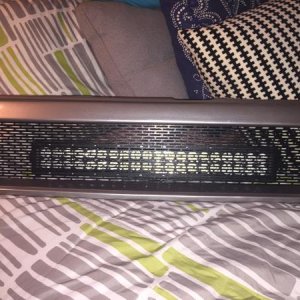The original game plan: mounting the light bar behind the grille mesh.  Unfortunately, there's not enough room. . .