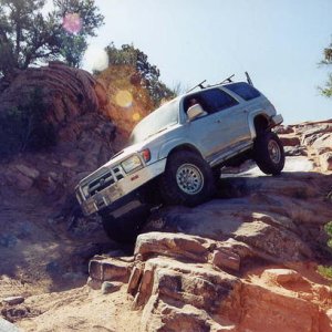Coming down the fun line on the High Dive obstacle on the Behind the Rocks trail near Moab, Utah.