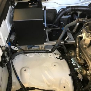 Relocating washer bottle and air pump