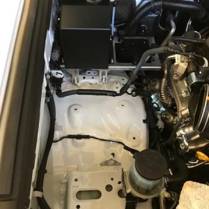 Relocating washer bottle and air pump