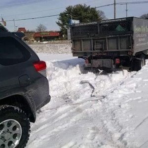Extricating a plow truck with the grocery getter.