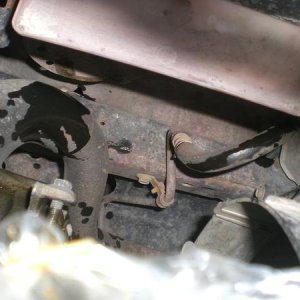 I pulled the hose from the reservoir and pushed it down next to the frame to drain as I turned the steering wheel from side to side.