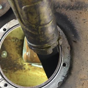 Flashlight looking into the same tank showing the rust at bottom.