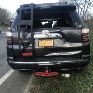 Rear-ended by a flatbed tow truck.